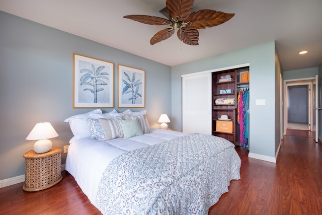 bedroom with dark wood-type flooring, ceiling fan, and a closet