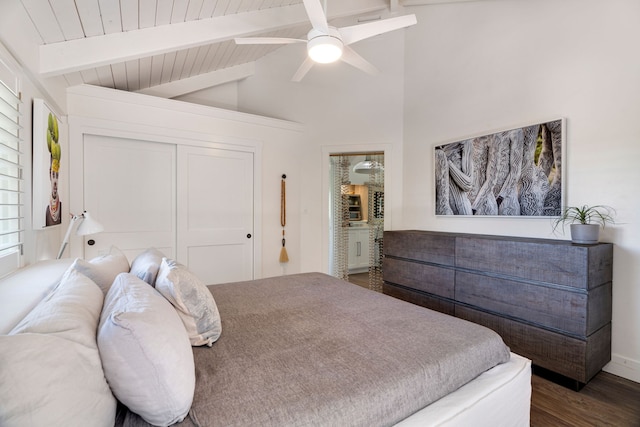 bedroom featuring lofted ceiling with beams, a closet, dark wood-type flooring, and ceiling fan