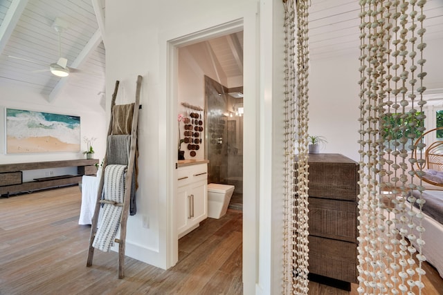 hallway with lofted ceiling with beams, wooden ceiling, and light hardwood / wood-style floors