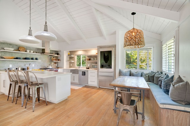 kitchen with tasteful backsplash, light hardwood / wood-style flooring, white cabinets, and stainless steel dishwasher