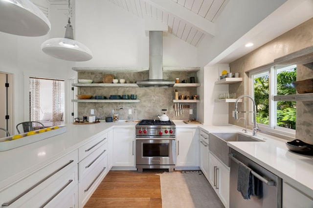 kitchen featuring light hardwood / wood-style flooring, stainless steel appliances, vaulted ceiling with beams, tasteful backsplash, and range hood