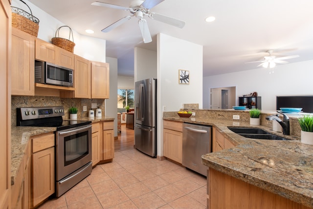 kitchen featuring appliances with stainless steel finishes, sink, ceiling fan, and light tile floors