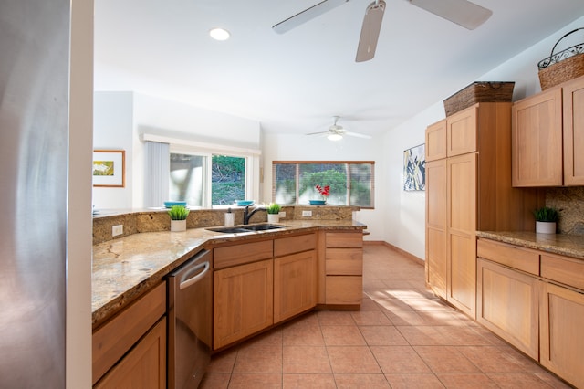 kitchen featuring ceiling fan, light stone countertops, stainless steel dishwasher, sink, and light tile floors