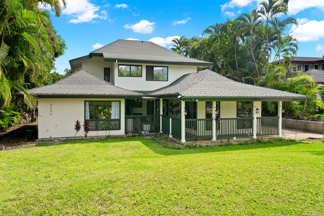 back of house featuring a lawn and a porch