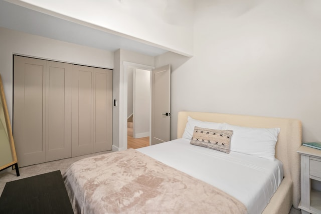 bedroom with a closet and light hardwood / wood-style floors