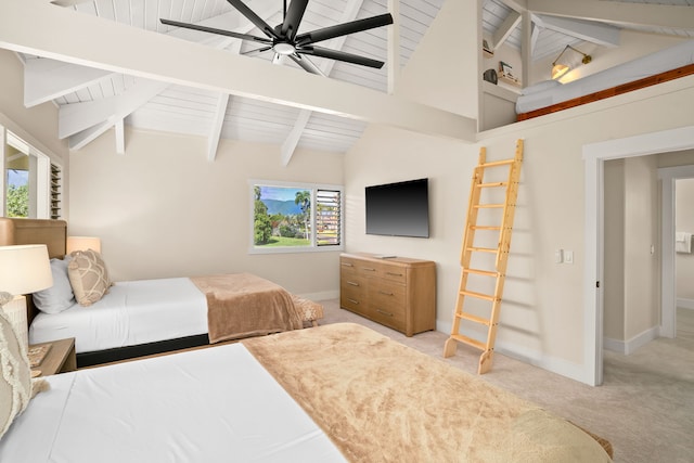 bedroom with beam ceiling, carpet flooring, multiple windows, and ceiling fan