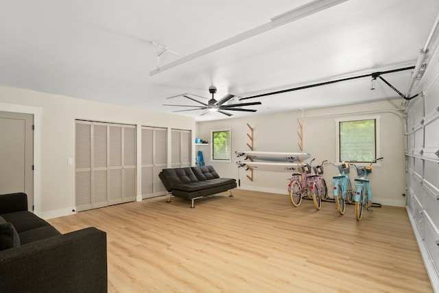 living room with ceiling fan, plenty of natural light, and light hardwood / wood-style floors