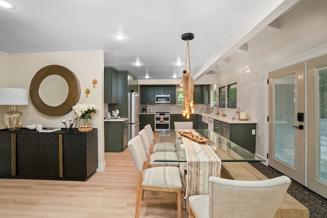 dining space featuring light hardwood / wood-style floors and french doors