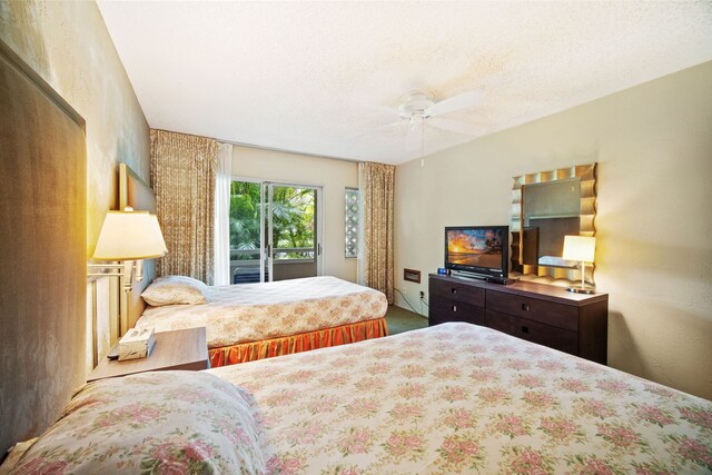 bedroom featuring a textured ceiling, carpet flooring, access to outside, and ceiling fan