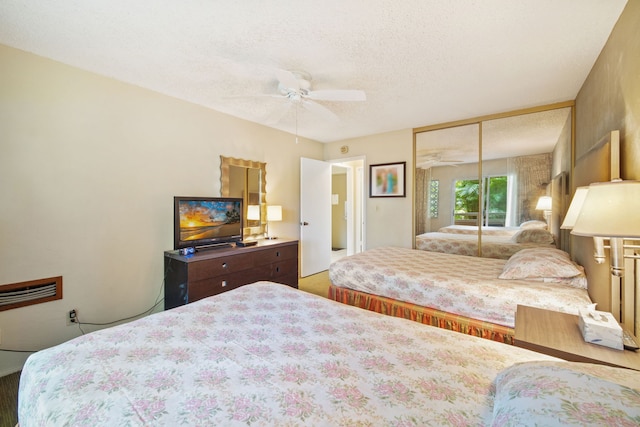 bedroom featuring a closet, a textured ceiling, and ceiling fan