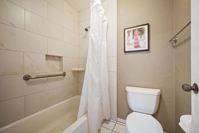 bathroom featuring tile patterned flooring, toilet, and shower / bathtub combination with curtain