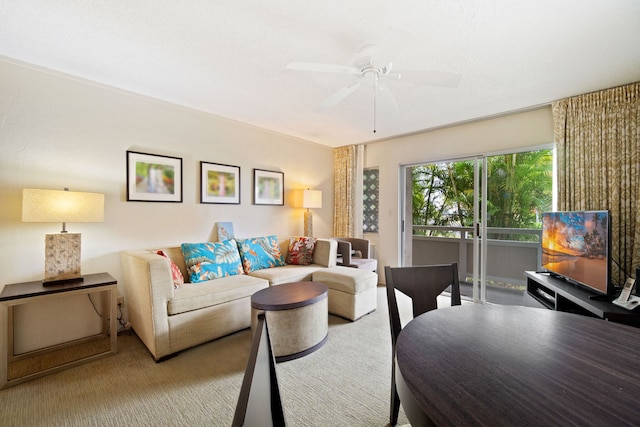 carpeted living room featuring a ceiling fan