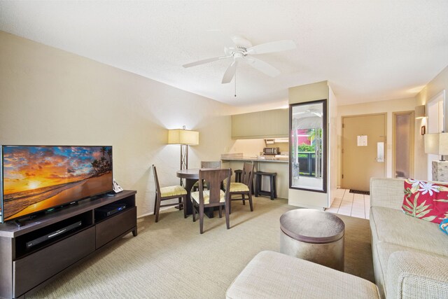 tiled living room with ceiling fan