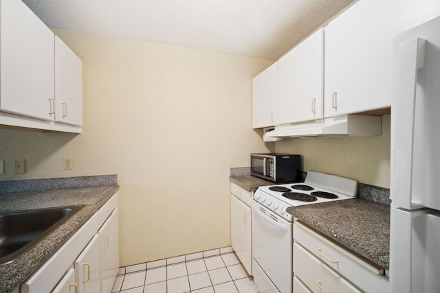 kitchen featuring white cabinetry, white appliances, dark countertops, and under cabinet range hood