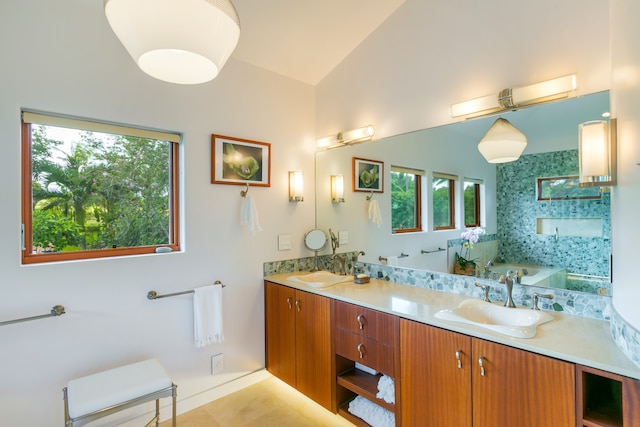 bathroom with vaulted ceiling, double vanity, tile floors, and a bathtub