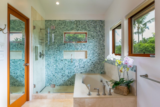 bathroom with tile flooring and plus walk in shower