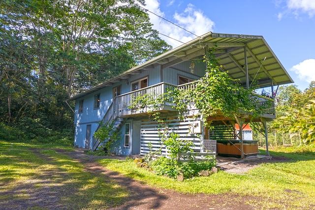 rear view of property featuring a yard