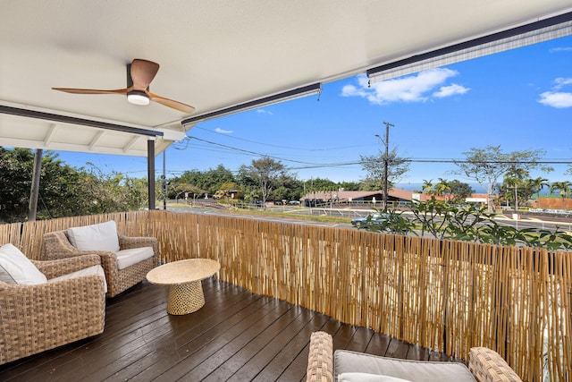 wooden terrace featuring an outdoor hangout area and ceiling fan