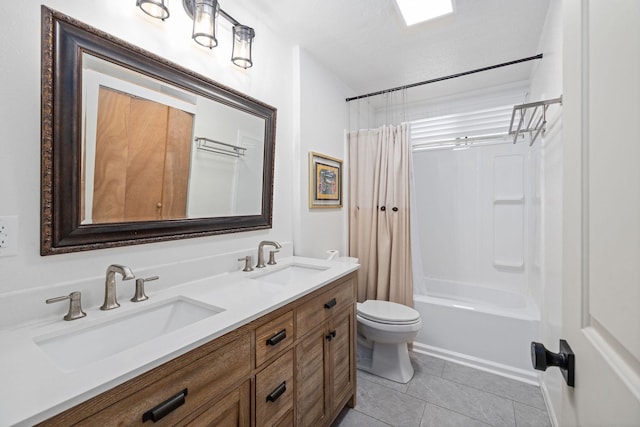 bathroom featuring a sink, toilet, double vanity, and tile patterned floors