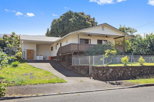 ranch-style house with stucco siding, a ceiling fan, aphalt driveway, fence, and a carport