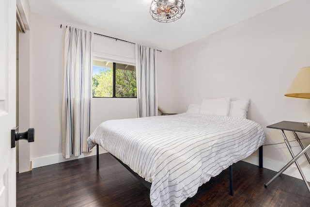 bedroom with wood finished floors and baseboards