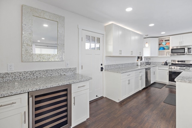 kitchen featuring wine cooler, white cabinetry, stainless steel appliances, and dark wood-type flooring