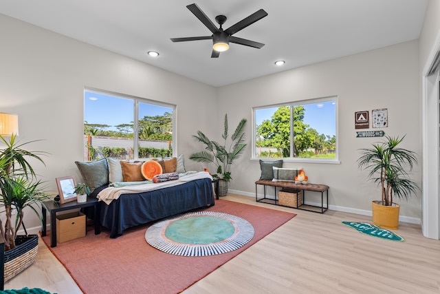 bedroom with ceiling fan and light hardwood / wood-style floors