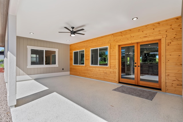 entrance to property featuring a patio area, ceiling fan, and french doors