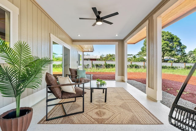 sunroom featuring ceiling fan