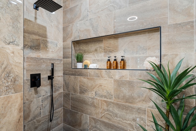 interior details featuring a tile shower