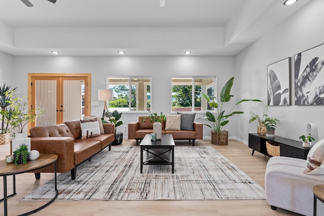 living room with ceiling fan and light hardwood / wood-style floors