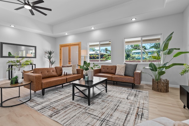 living room with ceiling fan and light hardwood / wood-style floors