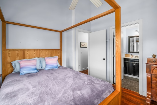 bedroom with sink, ensuite bathroom, and dark hardwood / wood-style floors