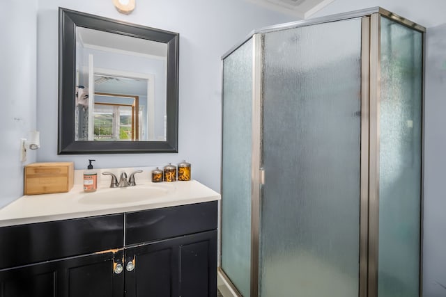 bathroom with an enclosed shower and vanity