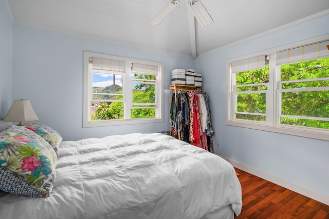 bedroom featuring hardwood / wood-style floors, lofted ceiling, and ceiling fan