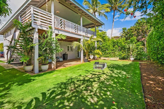 view of yard featuring a balcony and a patio