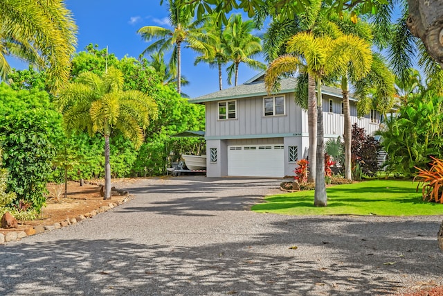 view of front of house featuring a garage and a front lawn