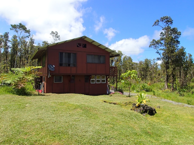 back of property featuring a yard