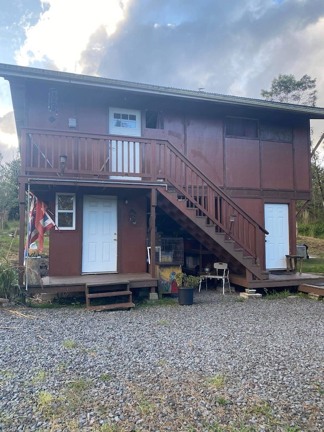 back of property featuring a deck