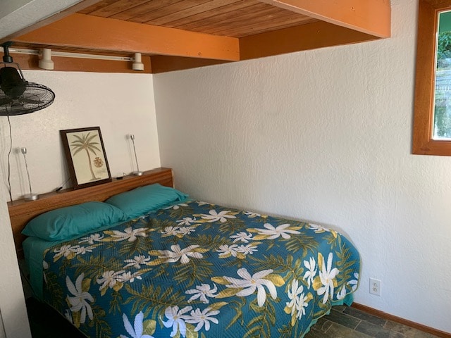 bedroom featuring wood ceiling and tile flooring