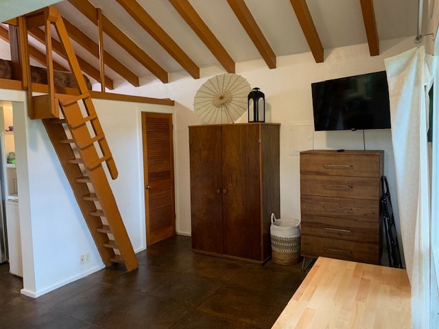 unfurnished bedroom featuring dark hardwood / wood-style floors and vaulted ceiling with beams