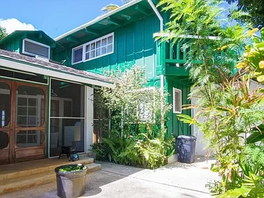 back of house featuring a sunroom