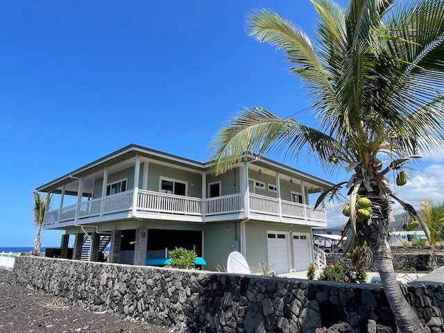 view of front of home with a balcony and a garage