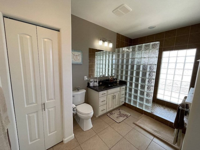 bathroom with tile floors, vanity, and toilet