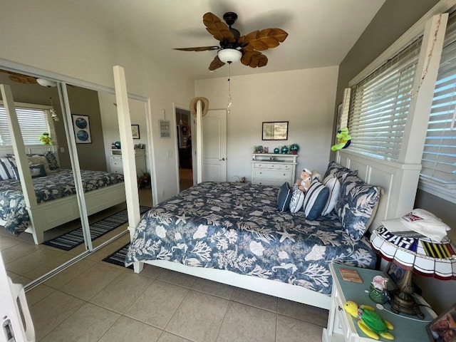 bedroom with tile flooring, multiple windows, and ceiling fan