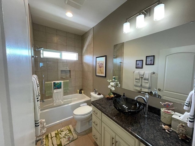 full bathroom with large vanity, tile floors, toilet, and tiled shower / bath