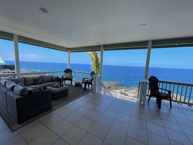 sunroom / solarium featuring a water view