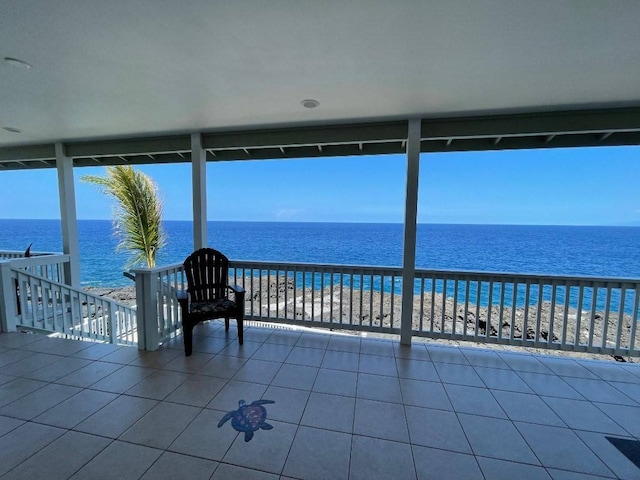 view of patio with a water view and a balcony