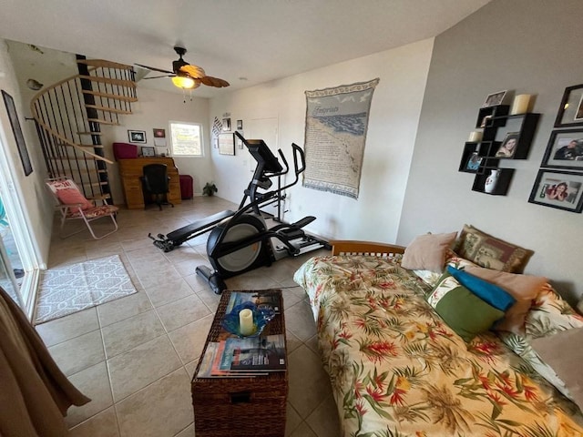 exercise room with tile floors and ceiling fan