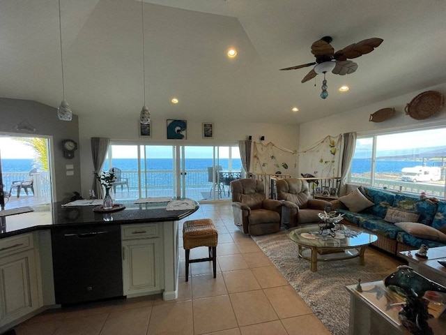 interior space featuring black dishwasher, a wealth of natural light, light tile flooring, and a water view